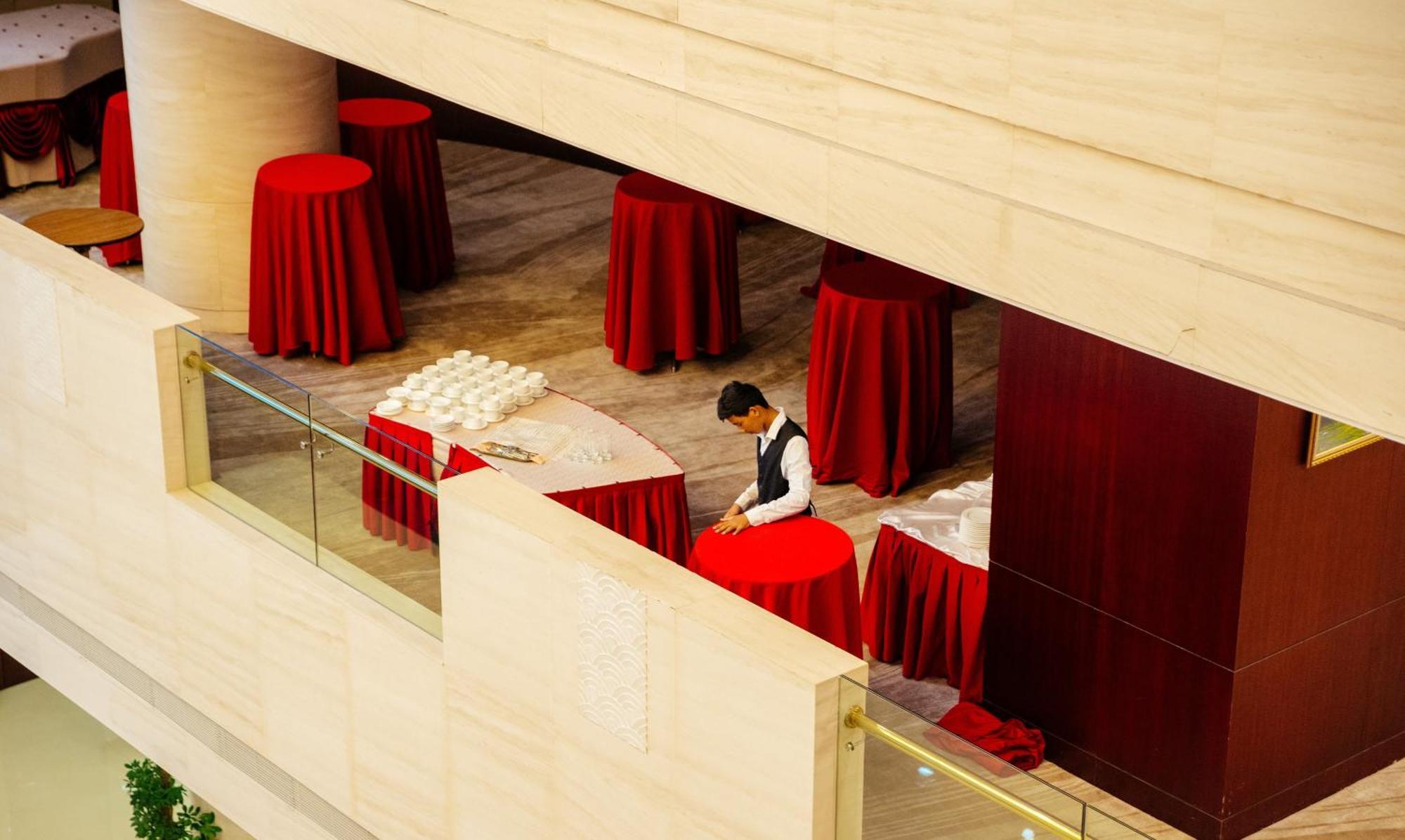 Beijing Palace Soluxe Hotel Astana Ngoại thất bức ảnh A hotel staff sets up a cocktail reception